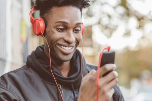 Afro american guy using smart phone on the street